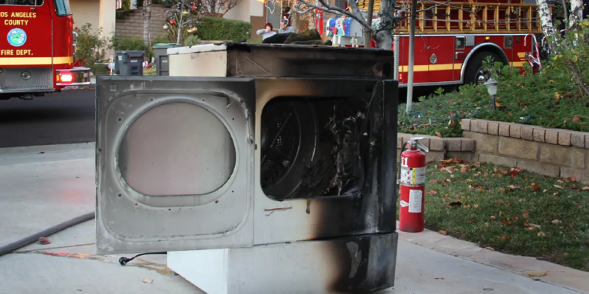 How does lint buildup in dryer vents increase fire risk?